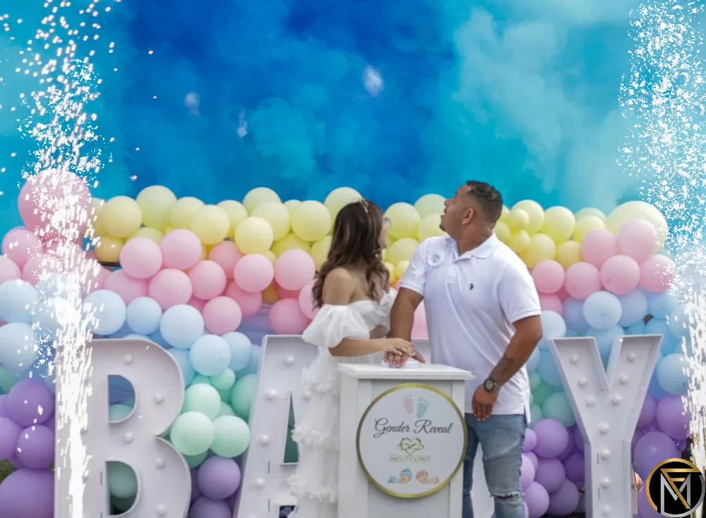 Blue smoke fills the sky as a couple reveals their baby is a boy at their gender reveal party
